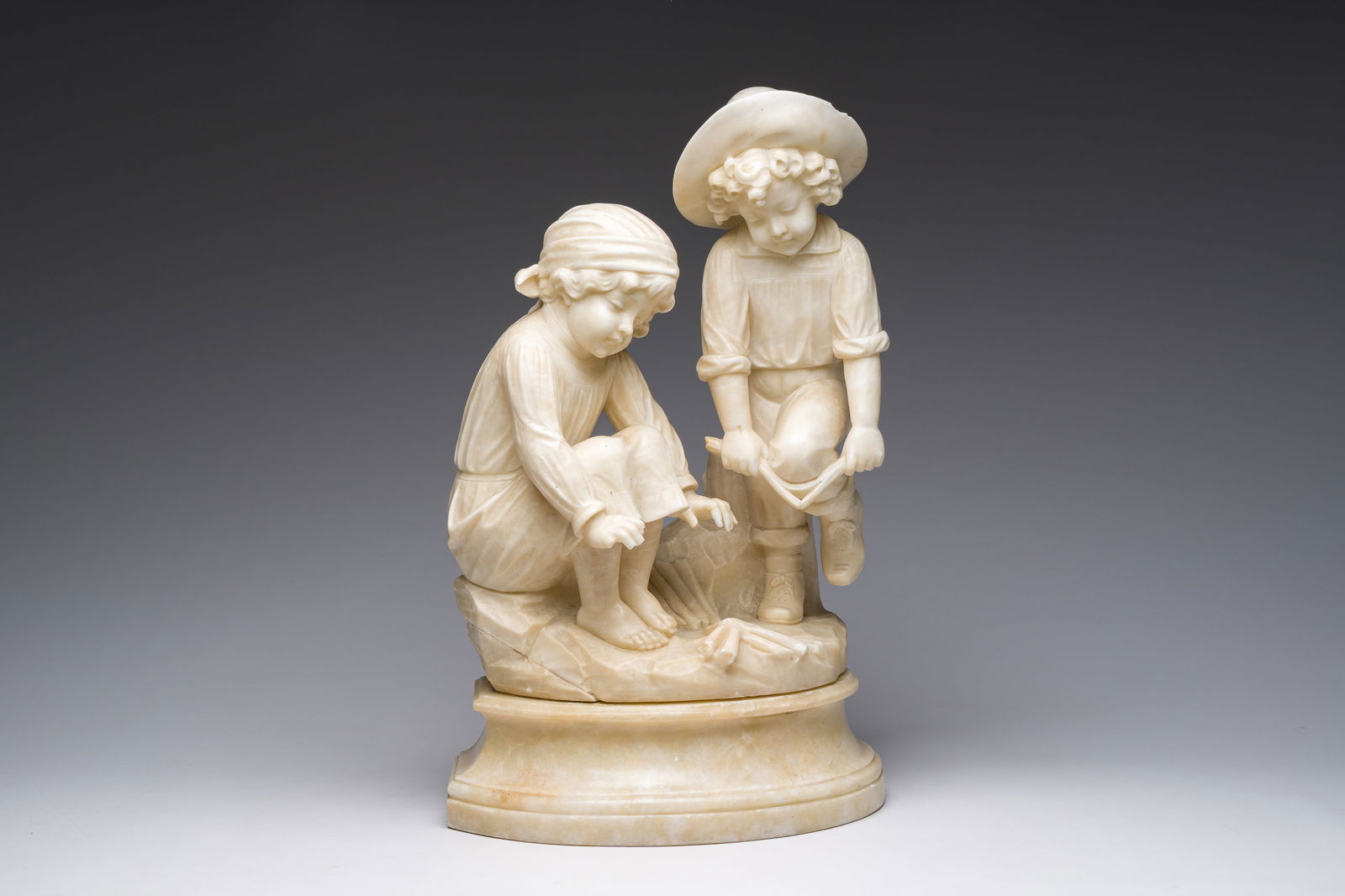 Italian school, attributed to Adolfo Cipriani (1857-1941): Two children warming themselves by the (1 of 7)