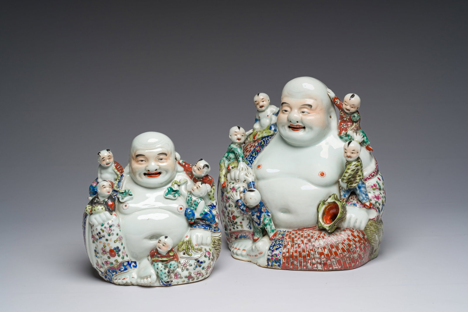 Two Chinese famille rose figures of Buddha with children, 19th/20th C. (1 of 7)