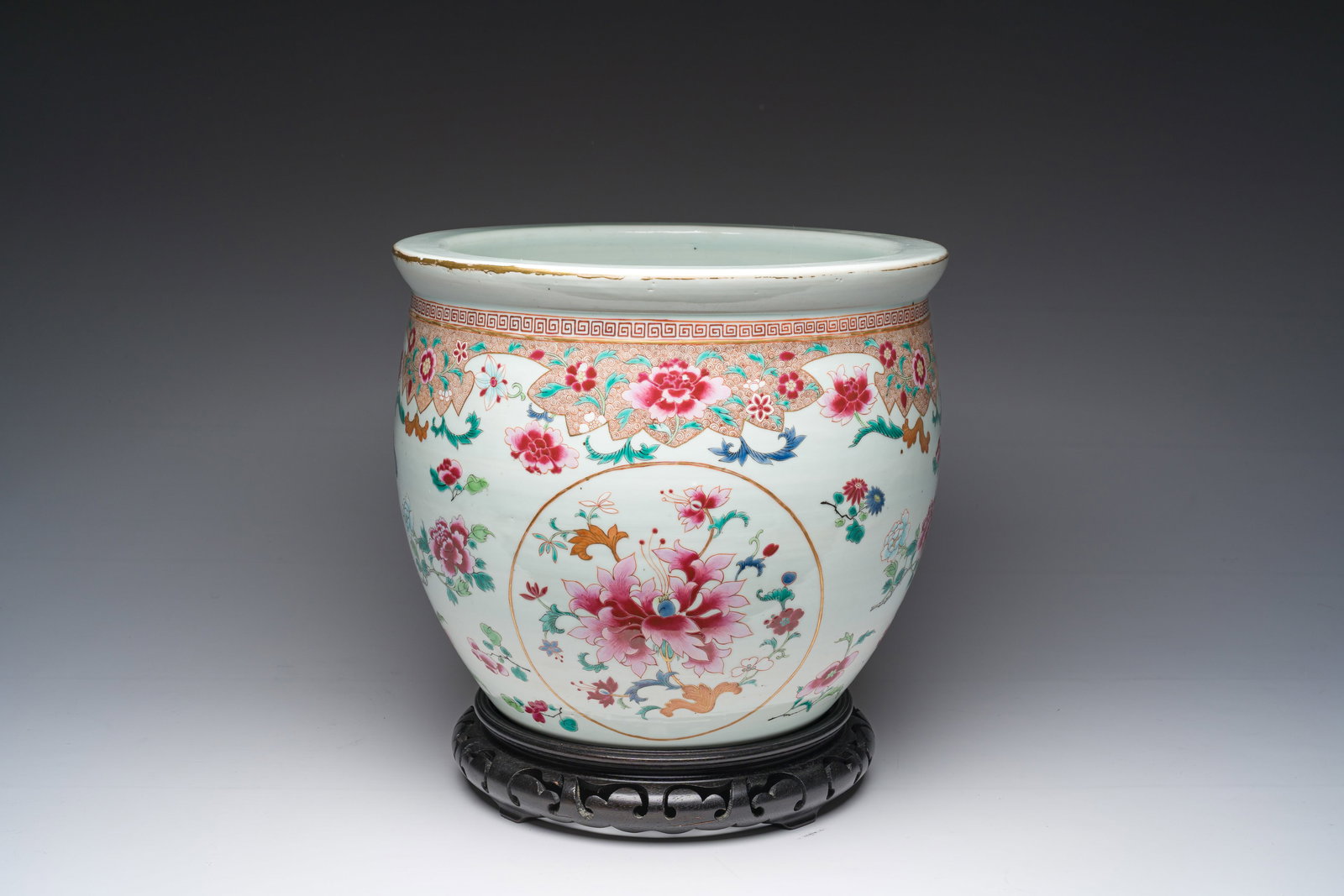 A Chinese famille rose jardiniere with floral design on a wooden base, 19th C. (1 of 10)