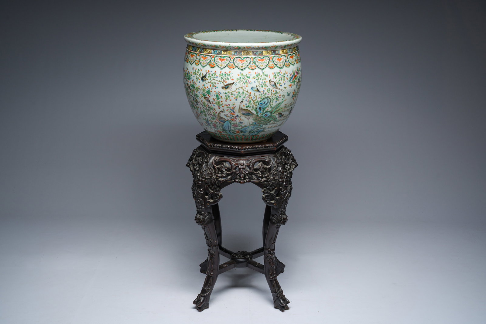 A Chinese famille rose jardiniere with birds on blossoming branches on an open worked carved wooden (1 of 8)