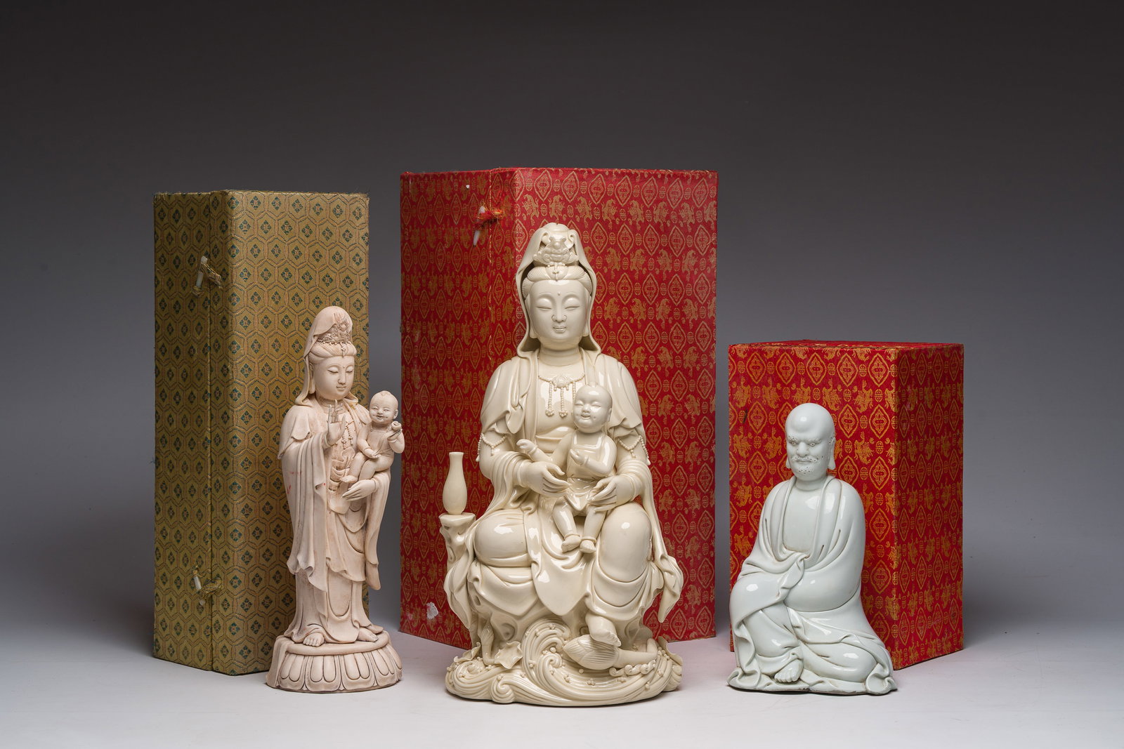 Two Chinese Blanc de Chine groups of Guanyin with child and a Luohan, 20th C. (1 of 14)