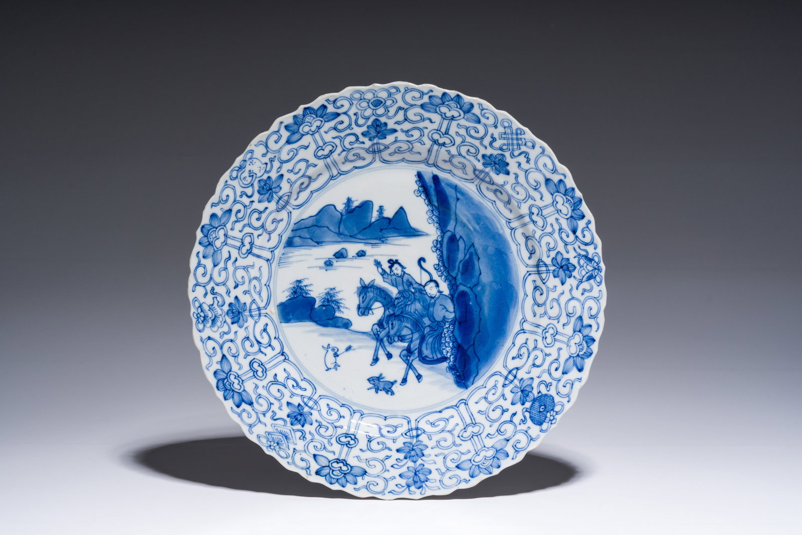 A Chinese blue and white 'Mongolian hunting' dish, Chenghua mark, Kangxi (1 of 2)