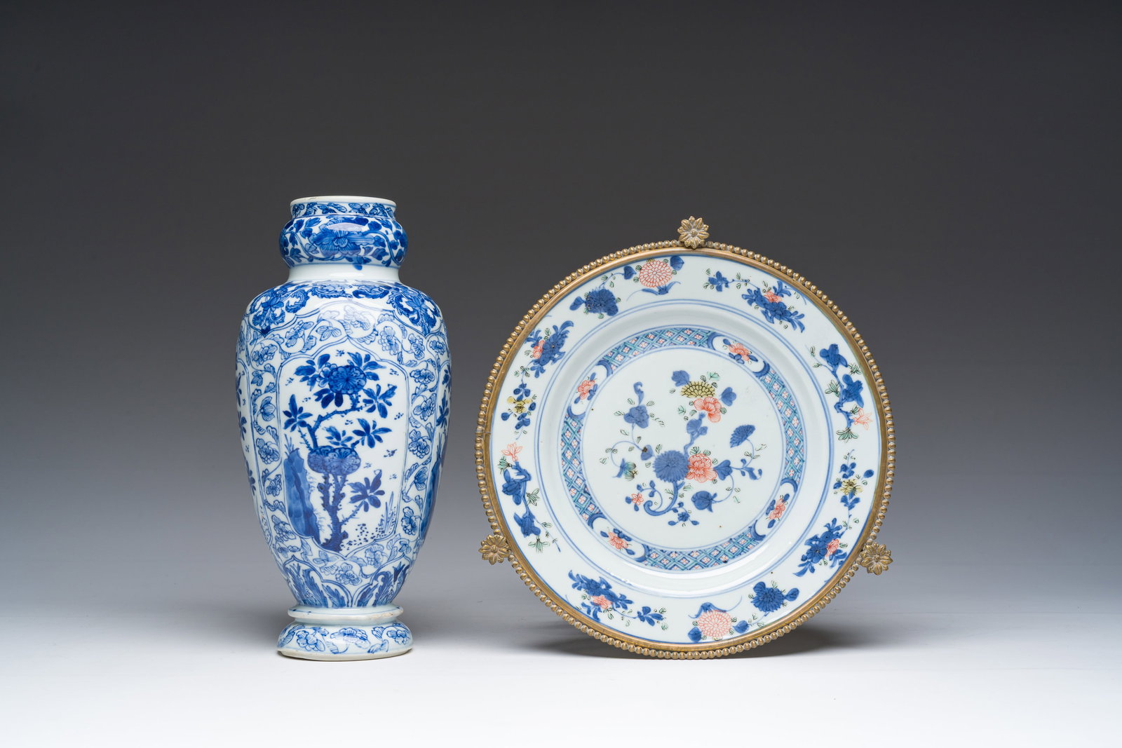 A Chinese blue and white vase and a gilt bronze mounted famille verte dish, Kangxi: A Chinese blue and white vase and a gilt bronze mounted famille verte dish, Kangxi H 26 cm (the vase) H 11 cm - Dia.: 23 (the dish incl. the mount)