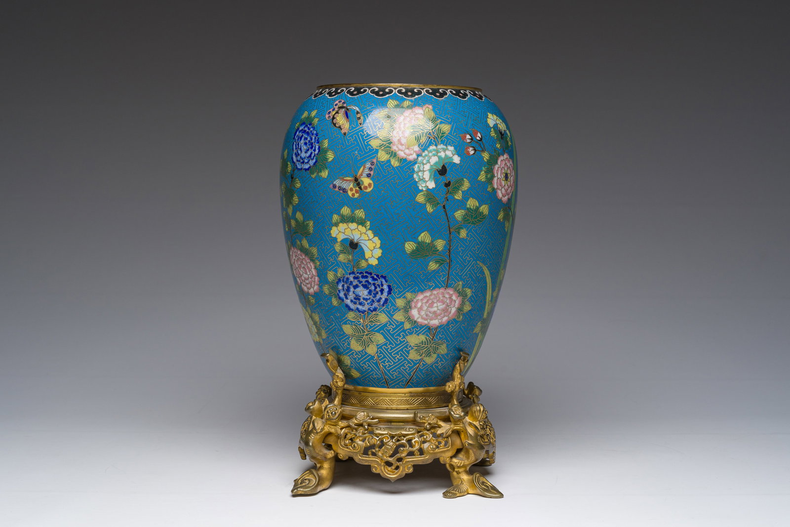 A Chinese cloisonne vase with butterflies among flowers mounted on a gilt bronze stand, 19th C. (1 of 9)