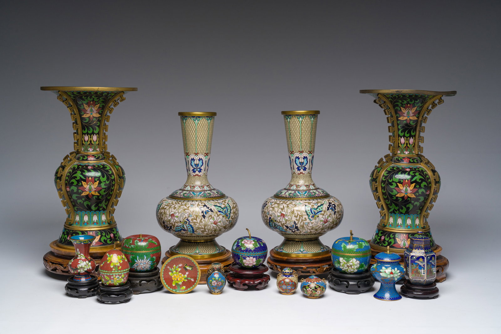 A varied collection of Chinese cloisonne vases with floral design, 20th C.: A varied collection of Chinese cloisonne vases with floral design, 20th C. H 25,5 cm (the largest pair of vases without stand) H 6 - 6,5 cm (the apple boxes without stand) Dia.: 6 cm (the saucer witho
