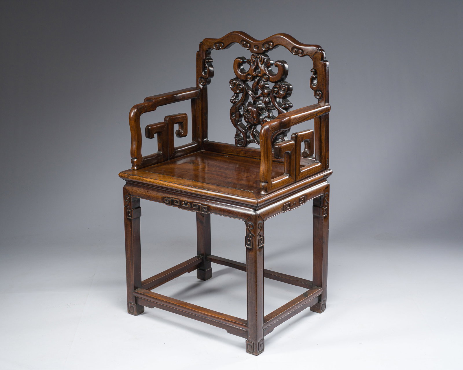 A Chinese carved and reticulated hardwood chair, 20th C. (1 of 11)