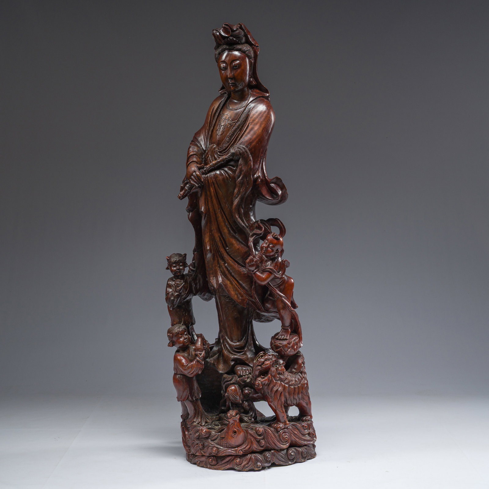 A large Chinese carved wooden figure of Guanyin with children, 20th C. (1 of 11)