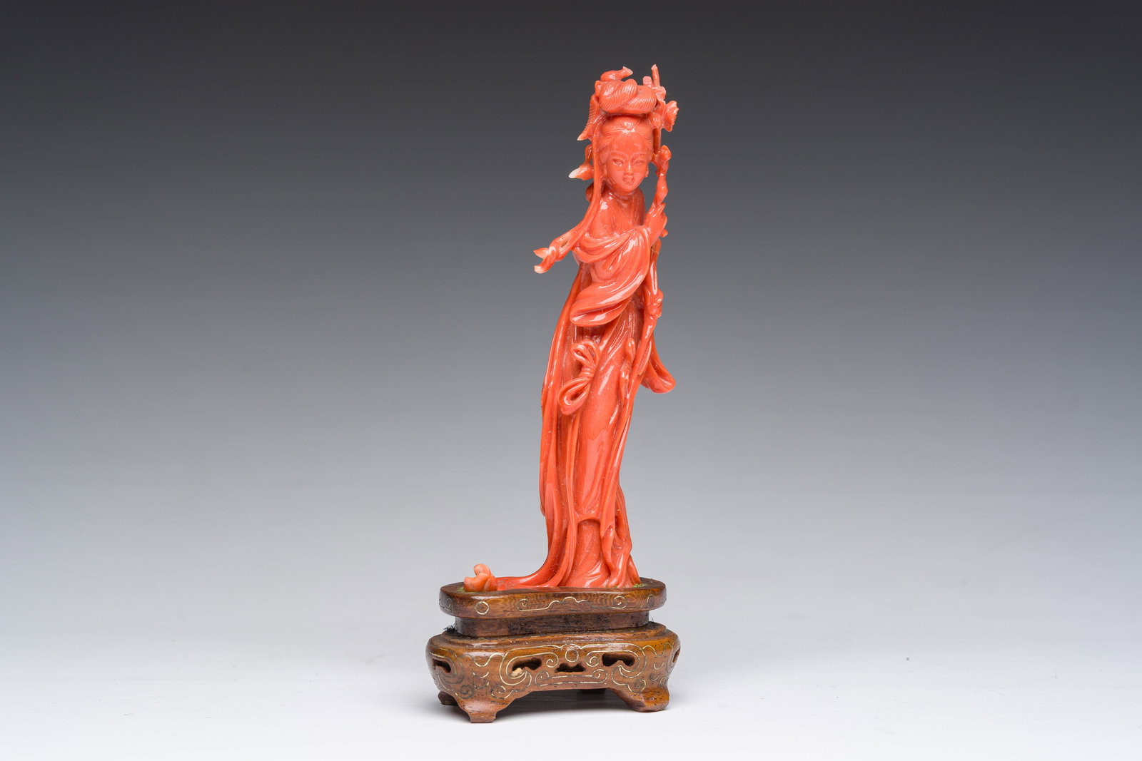 A Chinese carved red coral figure of a lady with a blossom branch, 19th/20th C. (1 of 7)