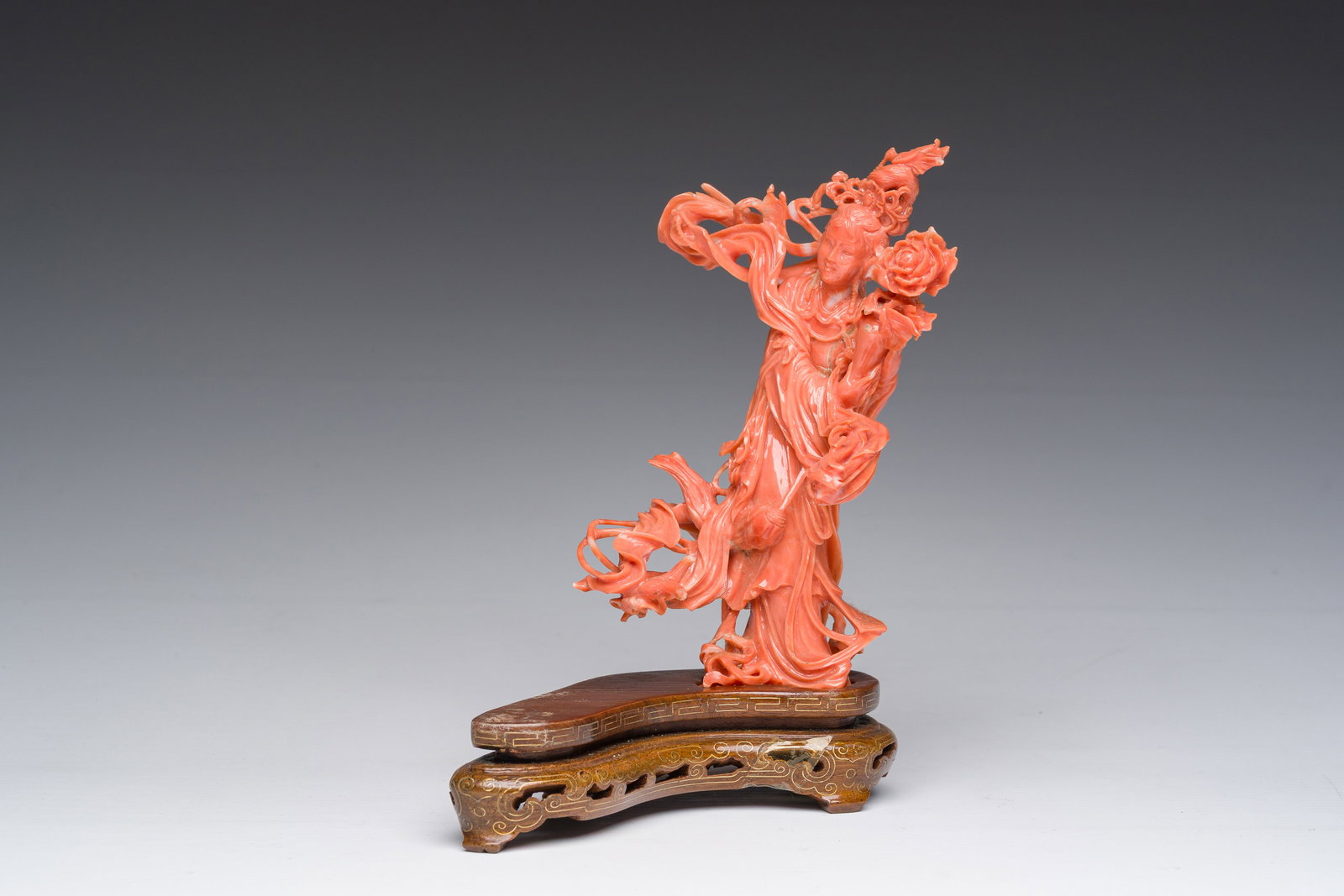 A Chinese carved red coral figure of a lady with a blossom branch, 19th/20th C. (1 of 10)