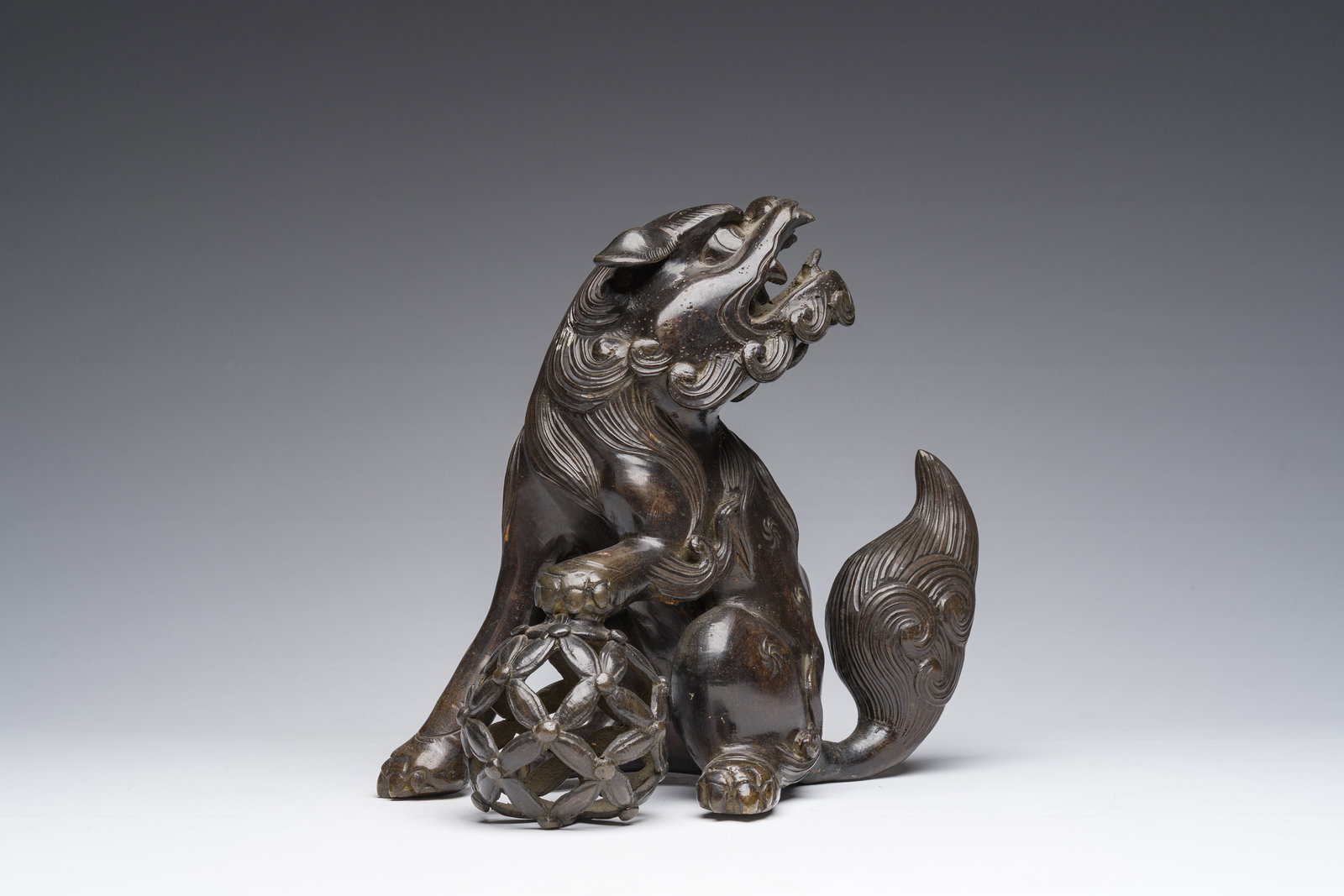 A Japanese bronze sculpture of a komainu or temple lion, Edo/Meiji, 19th C.: A Japanese bronze sculpture of a komainu or temple lion, Edo/Meiji, 19th C. H 21 - L 23 - D 14 cm