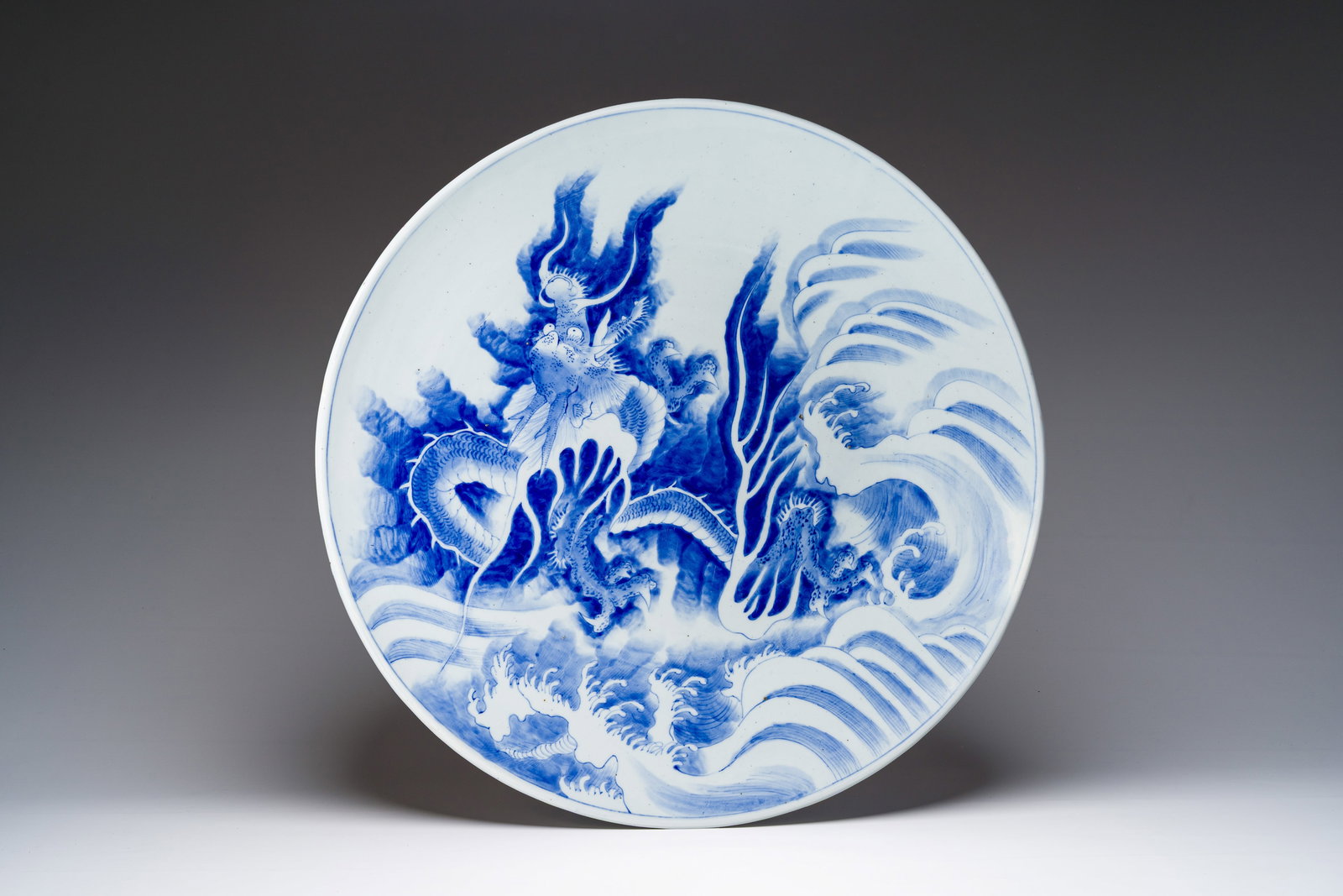 A massive blue and white Japanese 'dragon' dish, probaby Arita, Meiji, 19th C. (1 of 2)
