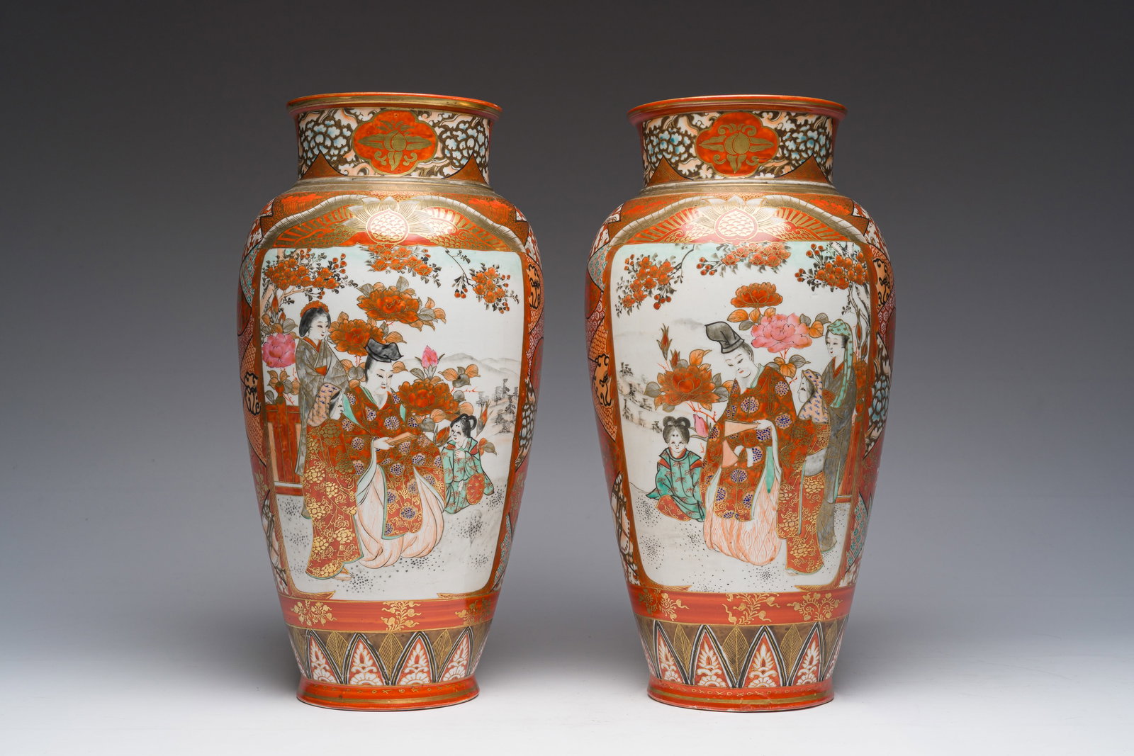 A pair of Japanese Kutani vases with birds among blossoming branches and figures in a landscape,: A pair of Japanese Kutani vases with birds among blossoming branches and figures in a landscape, Meiji, ca. 1900 H 35,5 cm