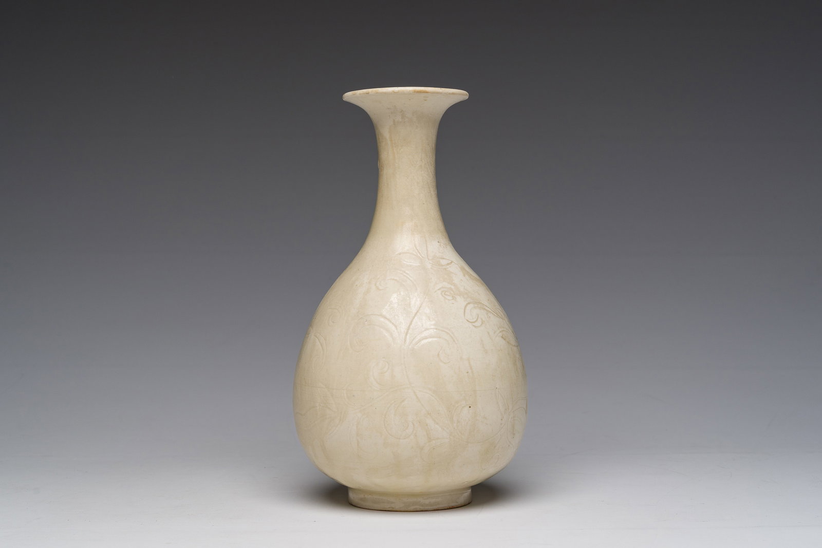 A Korean monochrome white glazed bottle vase with underglaze floral design, marked, 19th/20th C. (1 of 6)