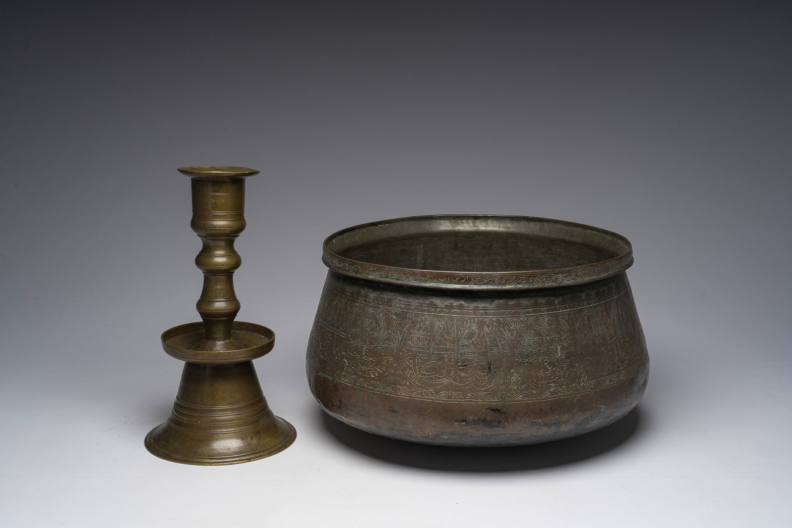 An Ottoman bronze candlestick and an Islamic tinned copper basin with engraved design, 19th C. (1 of 7)