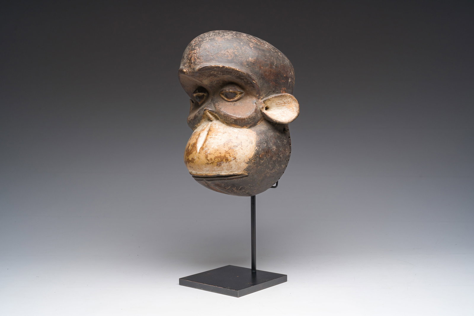 A Cameroonian Bulu carved and polychrome decorated monkey mask, 20th C. (1 of 6)