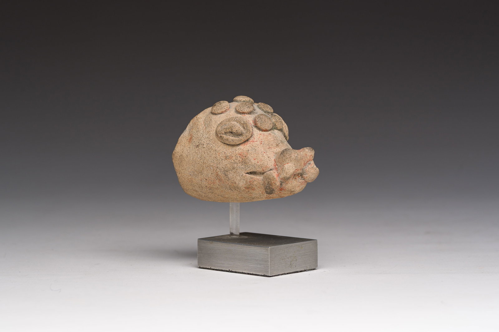 A terracotta head of an animal with traces of polychromy, presumably Iran, 6th-1st C. b.C. (1 of 7)