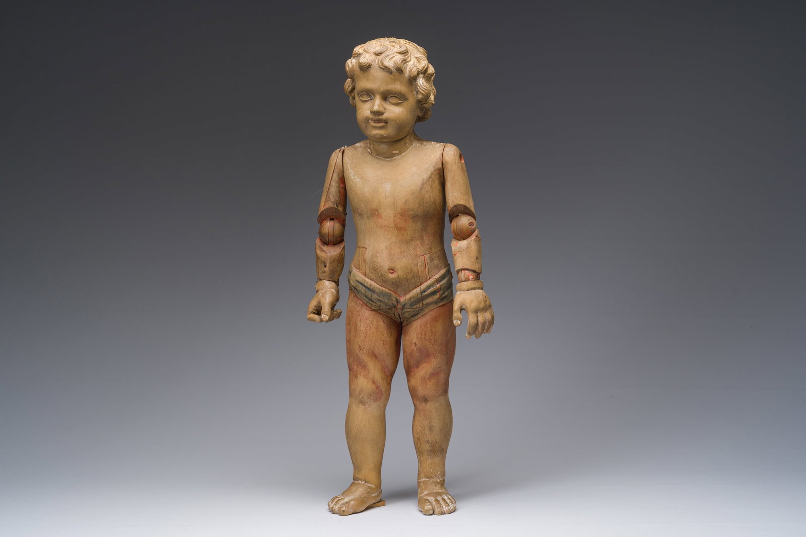 A carved and polychrome decorated wooden mannequin of Jesus as a child with a double movement (1 of 9)