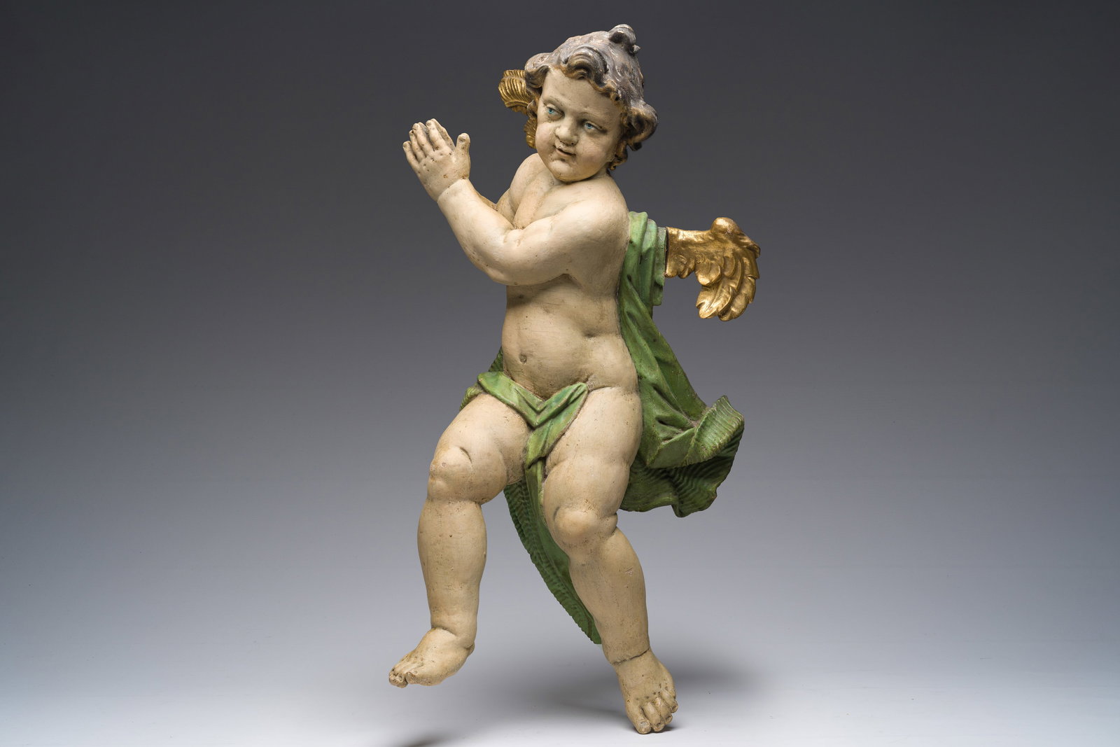A large German gilt and polychrome decorated limewooden angel, 18th C. (1 of 7)