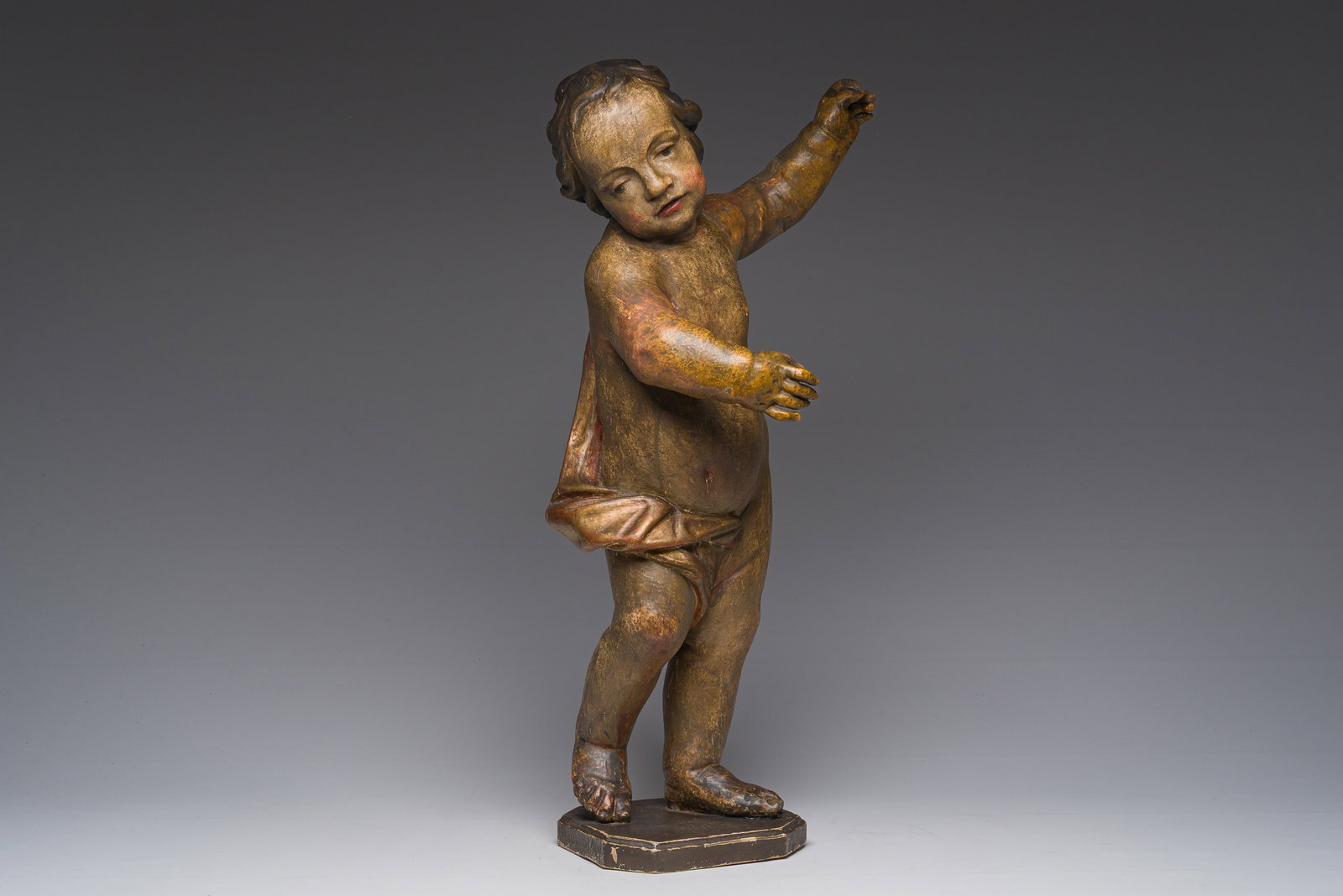 A gilt and polychrome wooden sculpture of a putto, 18th C. (1 of 8)