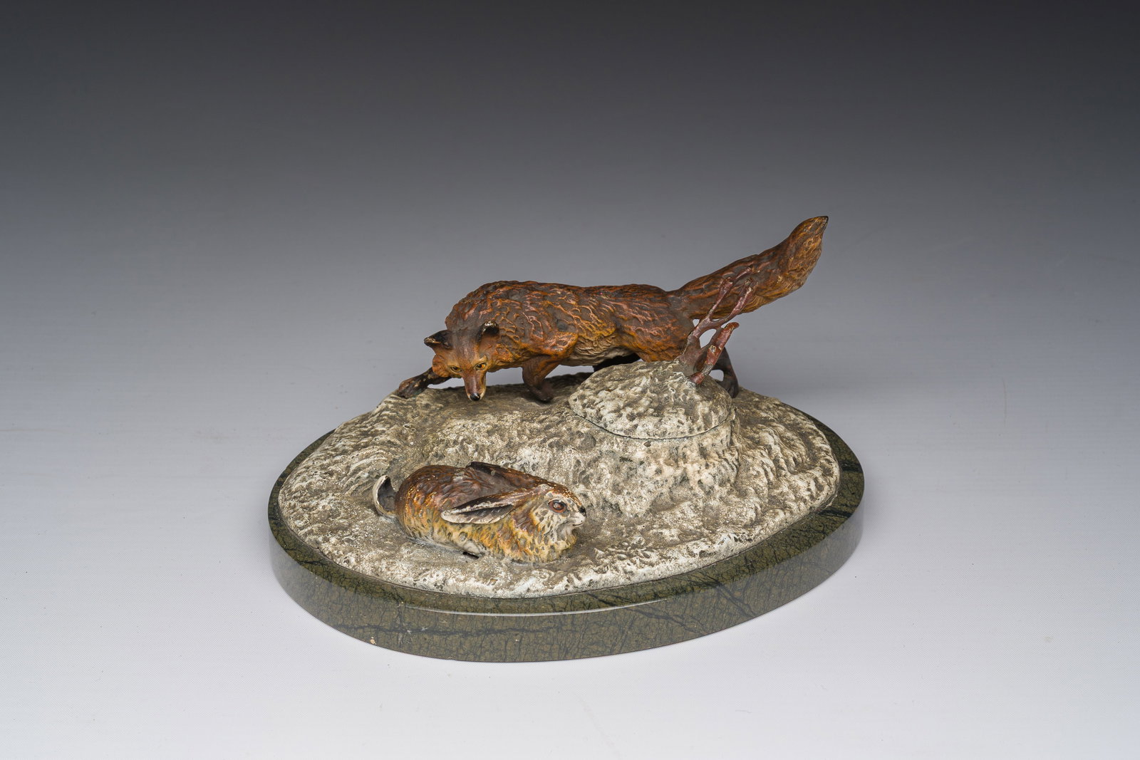 A Viennese cold painted bronze inkwell in the shape of a fox stalking a hare on a marble base, first (1 of 9)