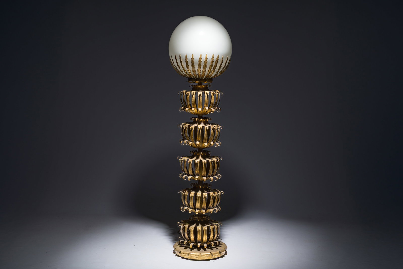 Maison Jansen (attr.): A gilt metal floor lamp crowned with a glowing globe, France, mid 20th C. (1 of 6)