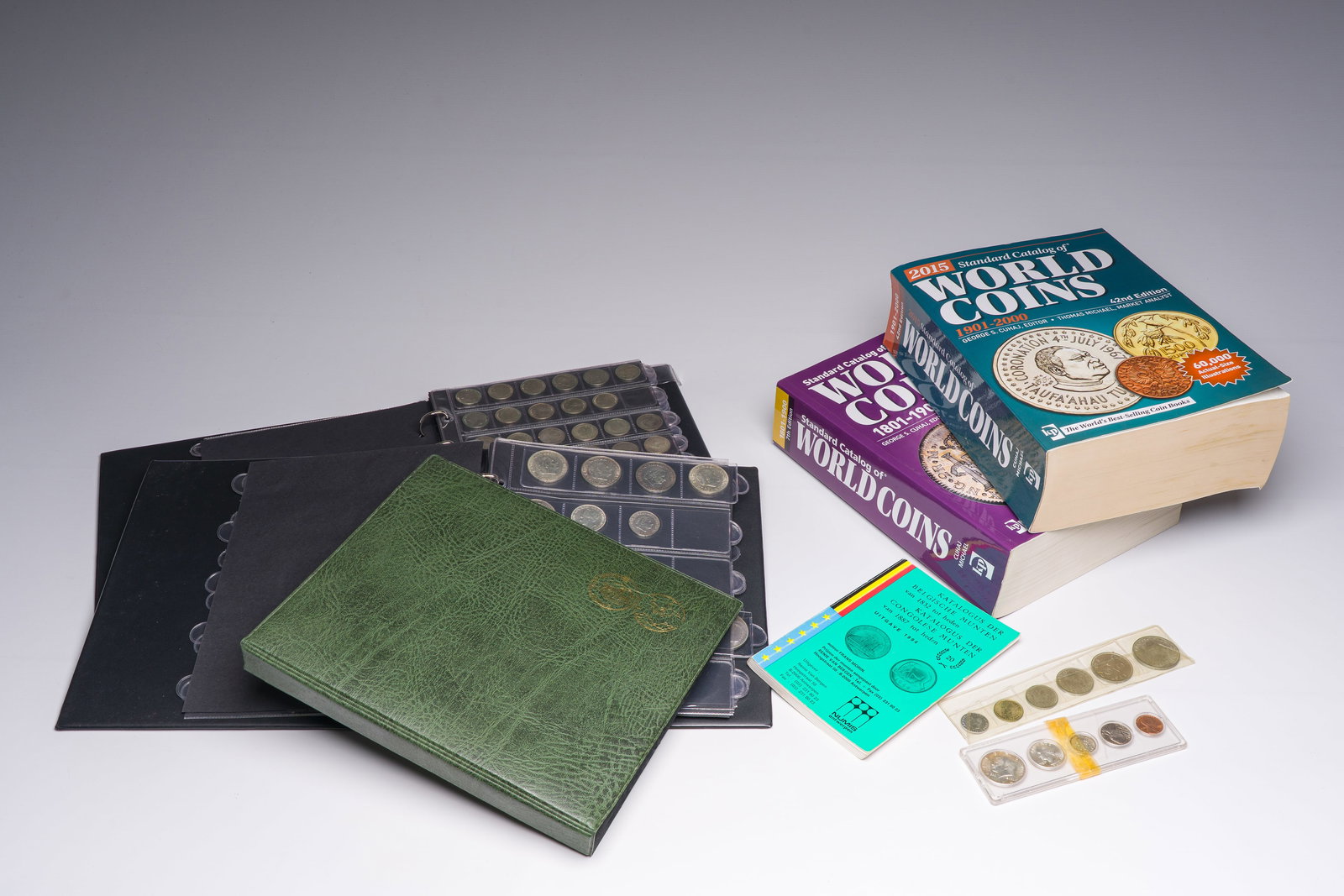 An extensive collection of mostly silver coins and tokens, accompanied by three publications, (1 of 7)