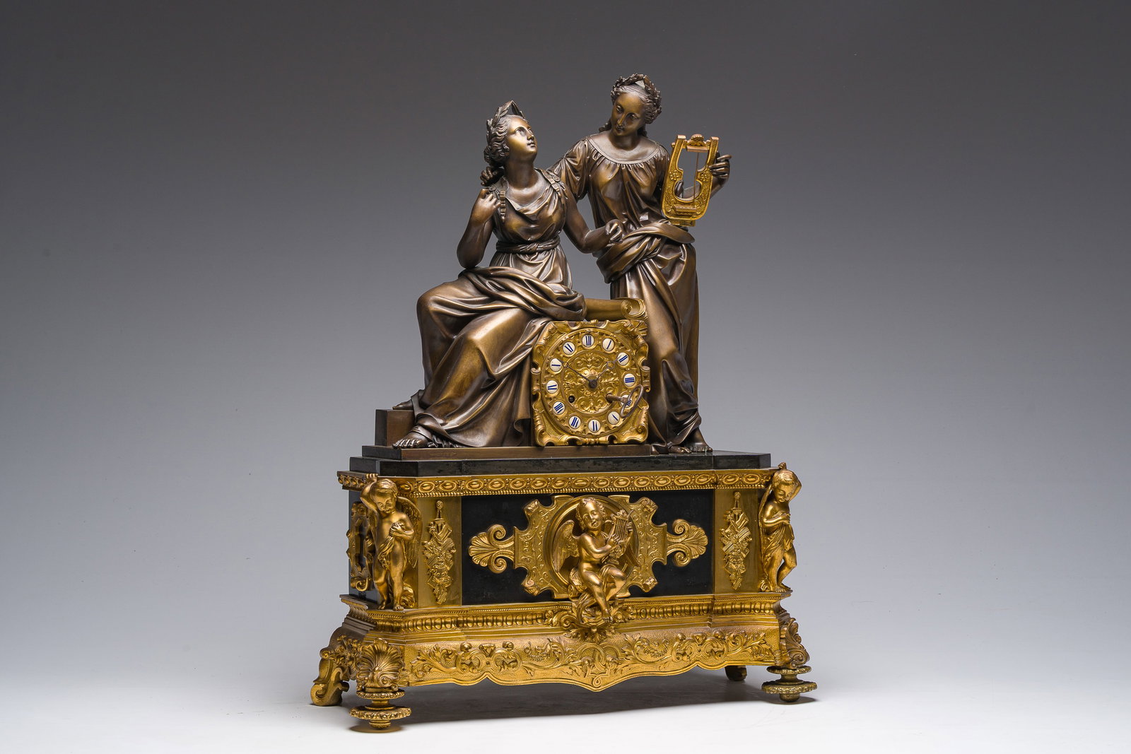 A French gilt bronze and black marble mantel clock crowned with two musicians, 19th C. (1 of 16)