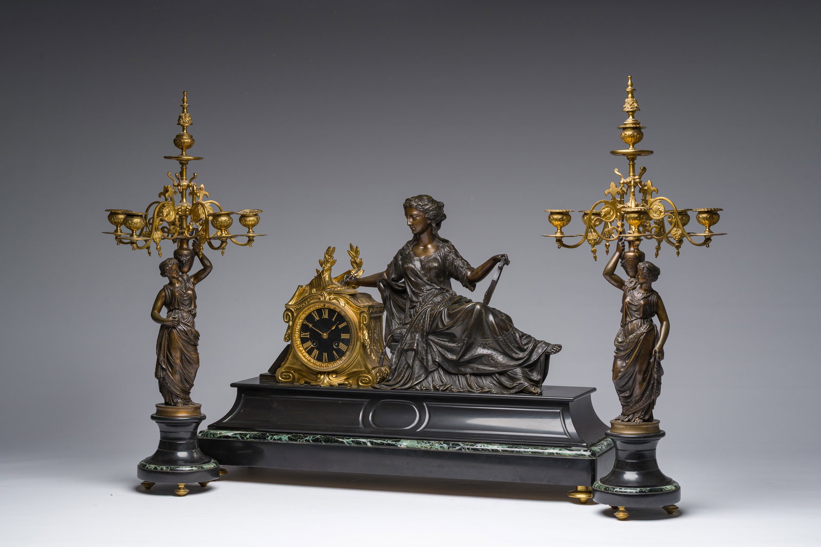 A French gilt and patinated bronze and marble three-piece clock garniture crowned with Erato, ca. (1 of 12)