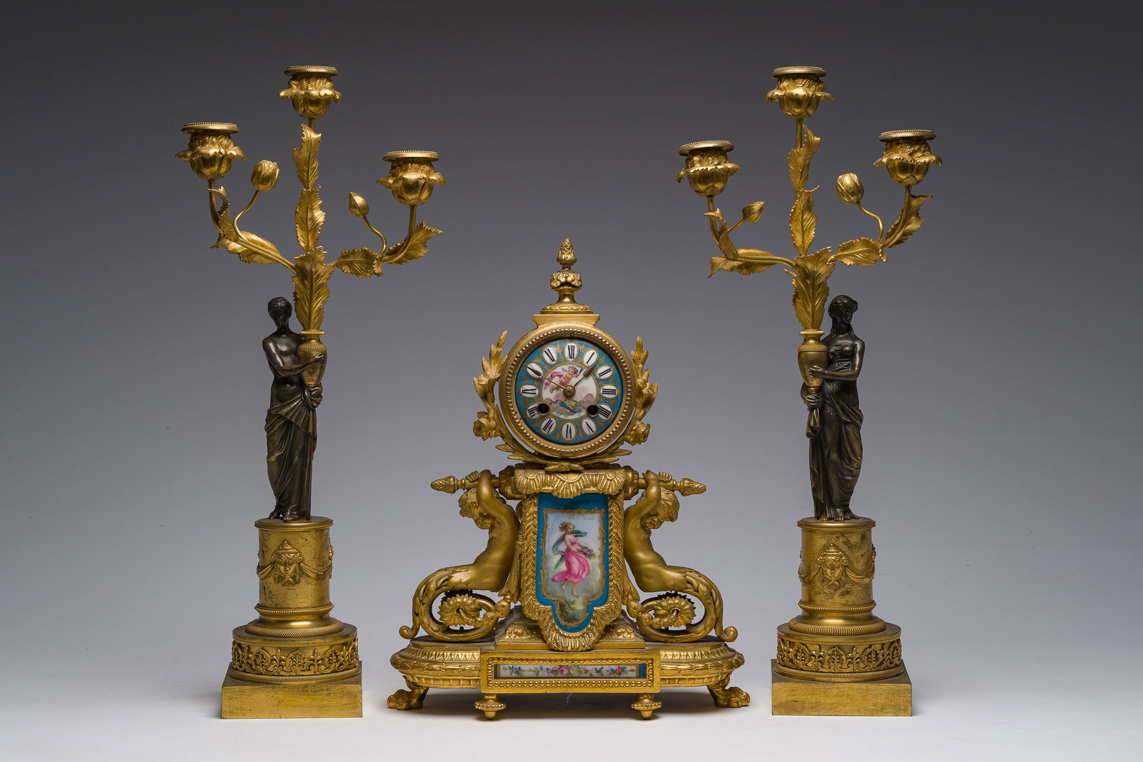 A French gilt bronze mantel clock with porcelain plaques and a pair of gilt and patinated bronze (1 of 8)