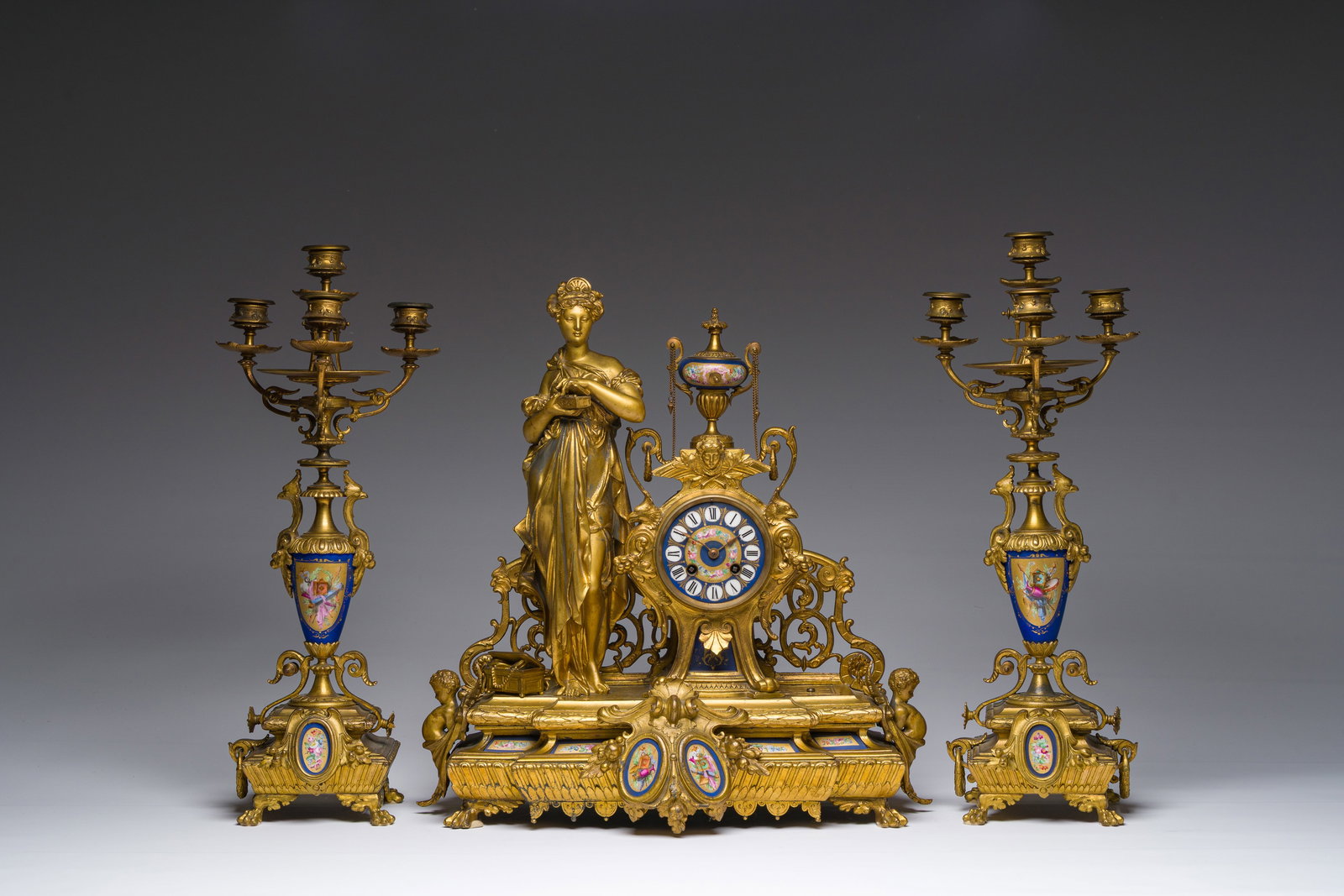 A French gilt bronze three-piece clock garniture crowned with a lady holding a jewelry box, 19th C. (1 of 8)