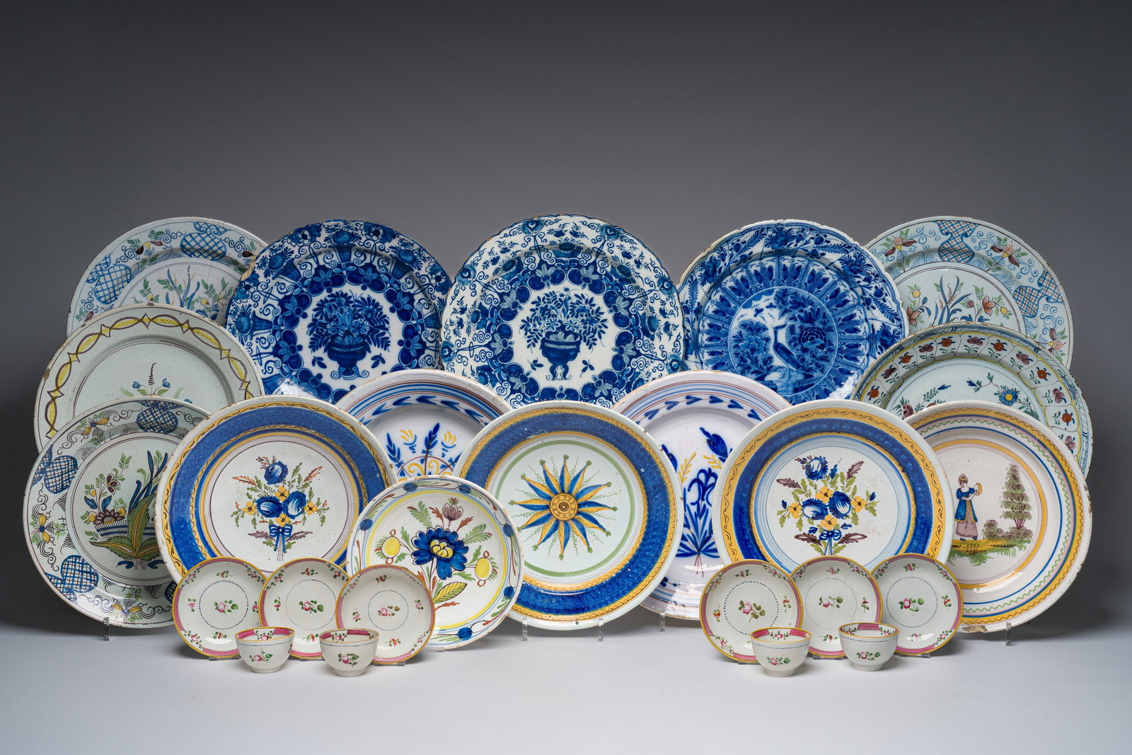A varied collection of blue, white and polychrome Dutch Delft and Brussels faience dishes, together (1 of 14)