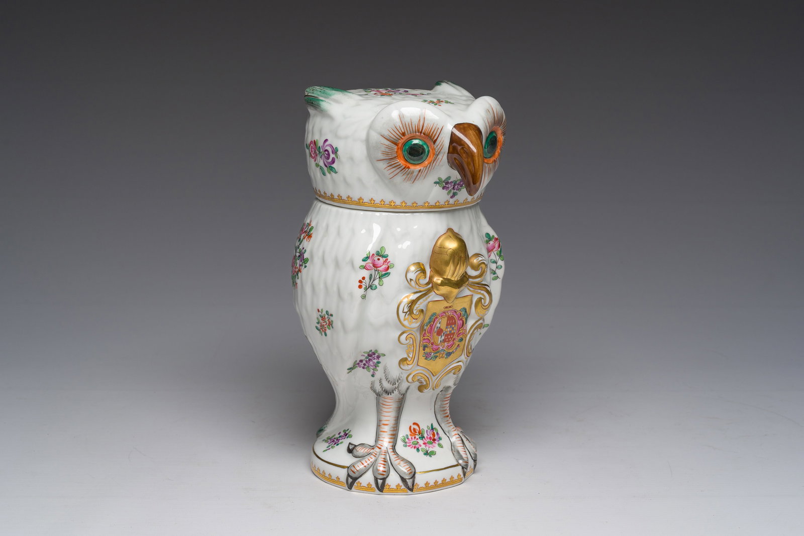 A French owl-shaped jar and cover in polychrome and gilt Paris porcelain with a coat of arms, 20th: A French owl-shaped jar and cover in polychrome and gilt Paris porcelain with a coat of arms, 20th C. H 24,5 cm The base with a 'Porcelaine de Paris' label and mark. Ref.:- A quite similar pair of Sam