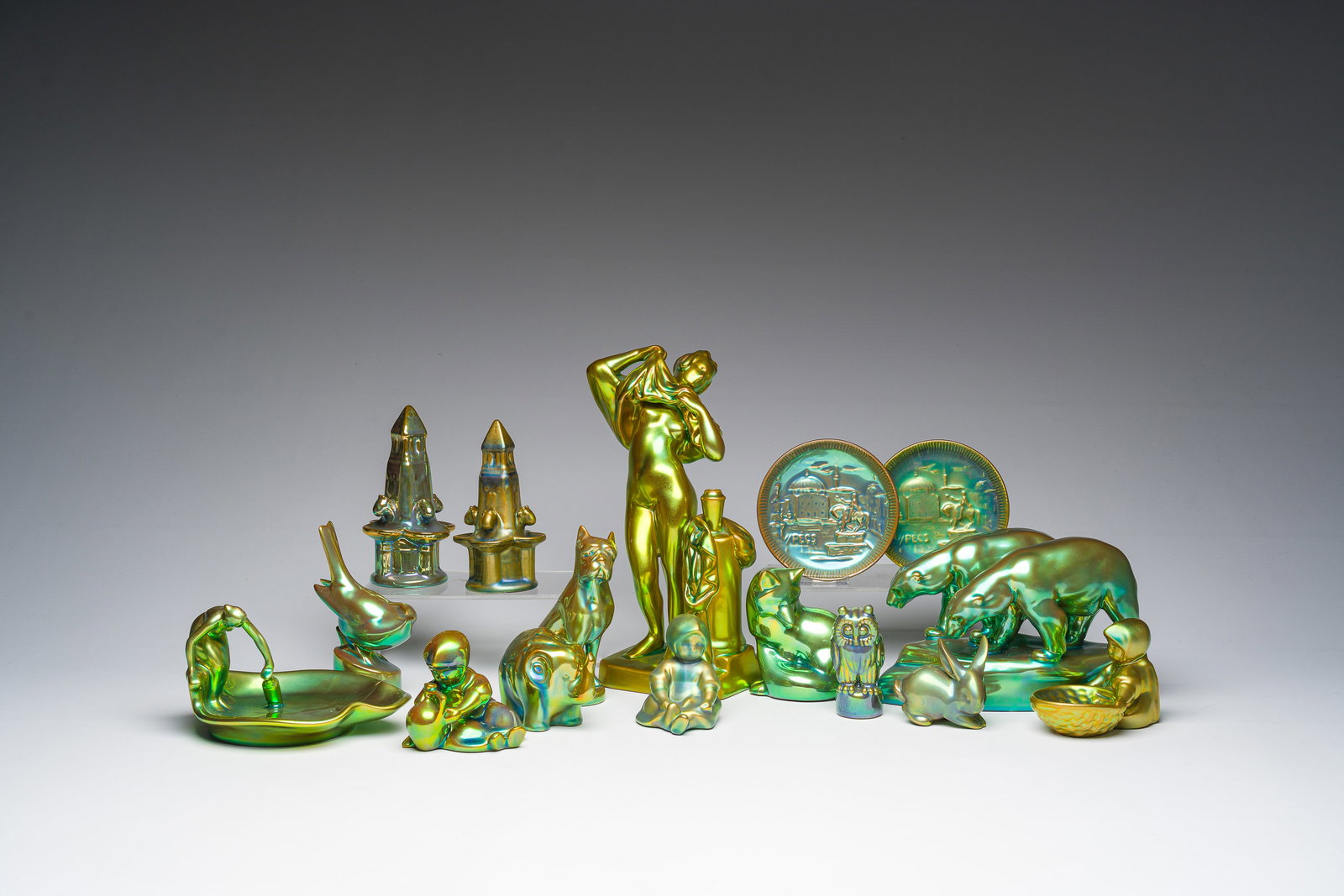A varied collection of Hungarian Zsolnay Pecs eosine glazed animals, figures and monuments, 20th C. (1 of 6)