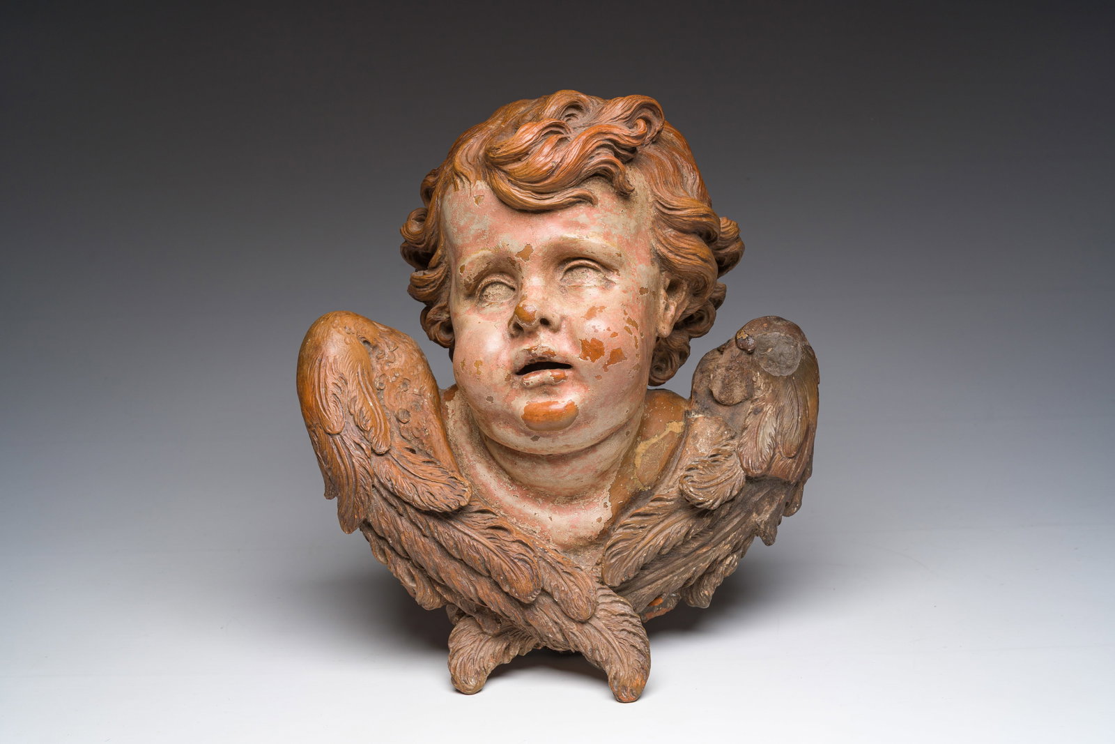 A polychromed terracotta cherub head, probably France, 18th/19th C. (1 of 7)
