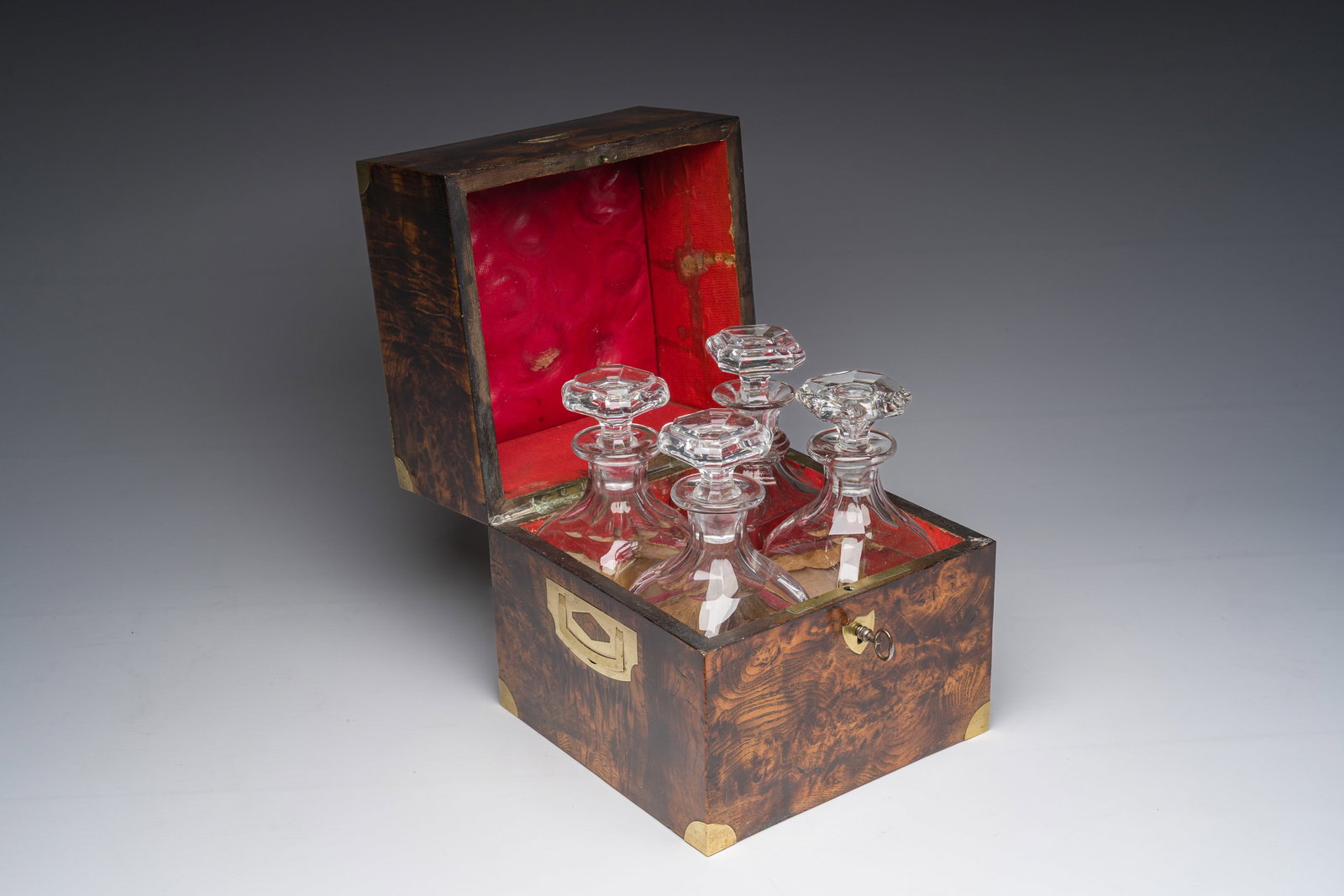 A French burl wooden veneered and brass-inlaid 'cave a liqueur' with four glass carafes, 19th C. (1 of 6)
