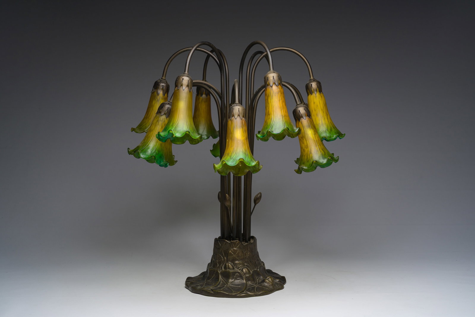 An Art Nouveau style twelve-light patinated metal table lamp in the manner of the iconic 'Tiffany (1 of 8)