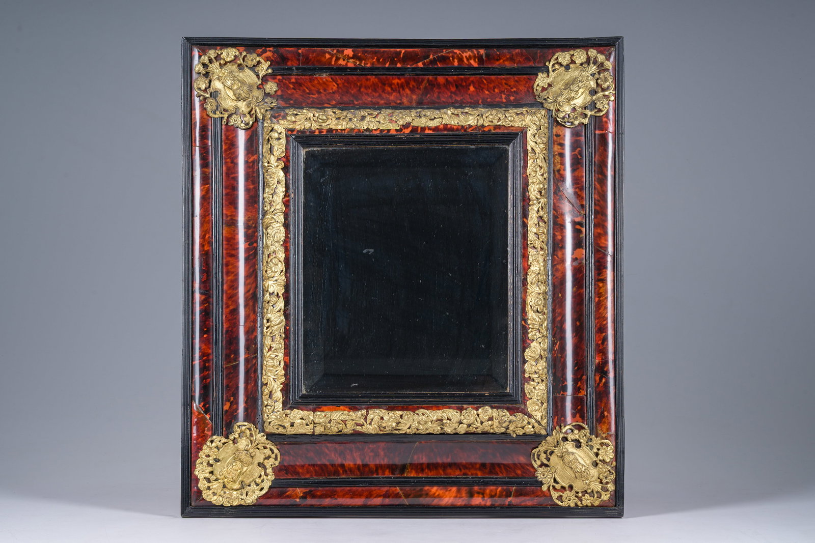 A rectangular gilt bronze mounted tortoise shell veneer and ebonized wooden mirror frame, probably (1 of 4)