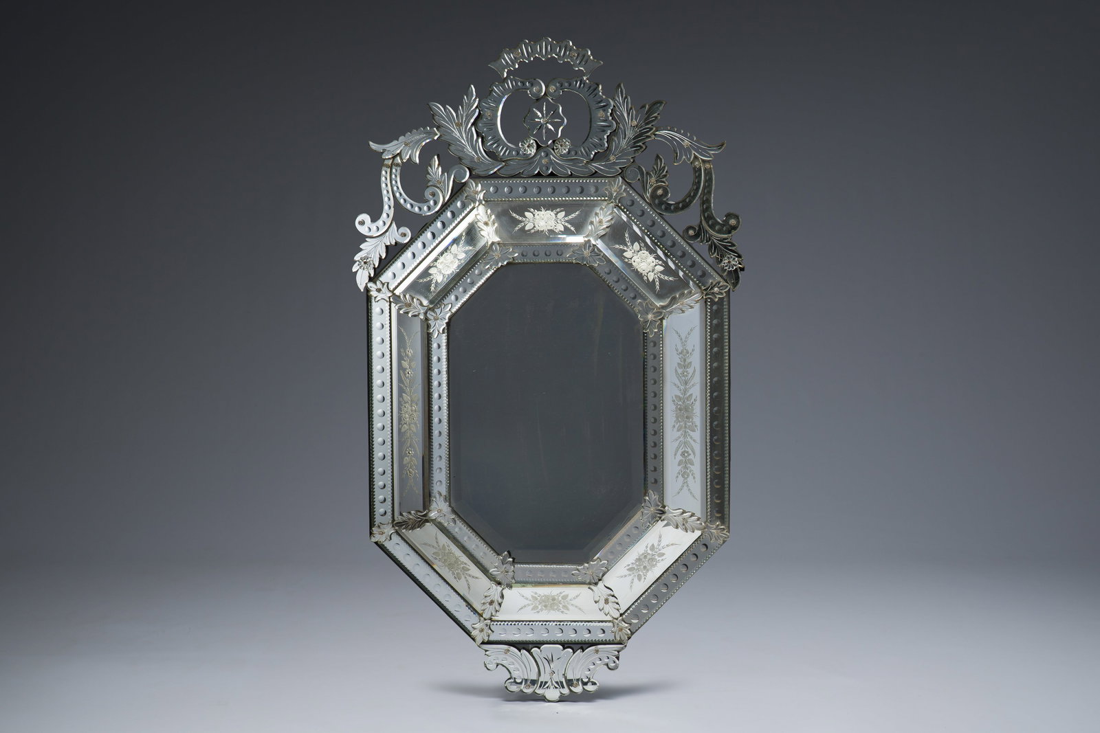 A Venetian octagonal mirror in partially cut and etched glass with floral design, Italy, 20th C. (1 of 2)