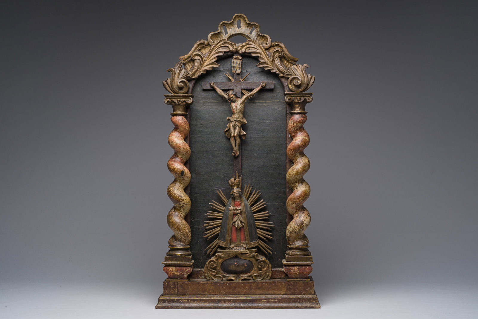 A Spanish carved and polychrome decorated wooden house altar with a crucified Christ and a Mater (1 of 7)