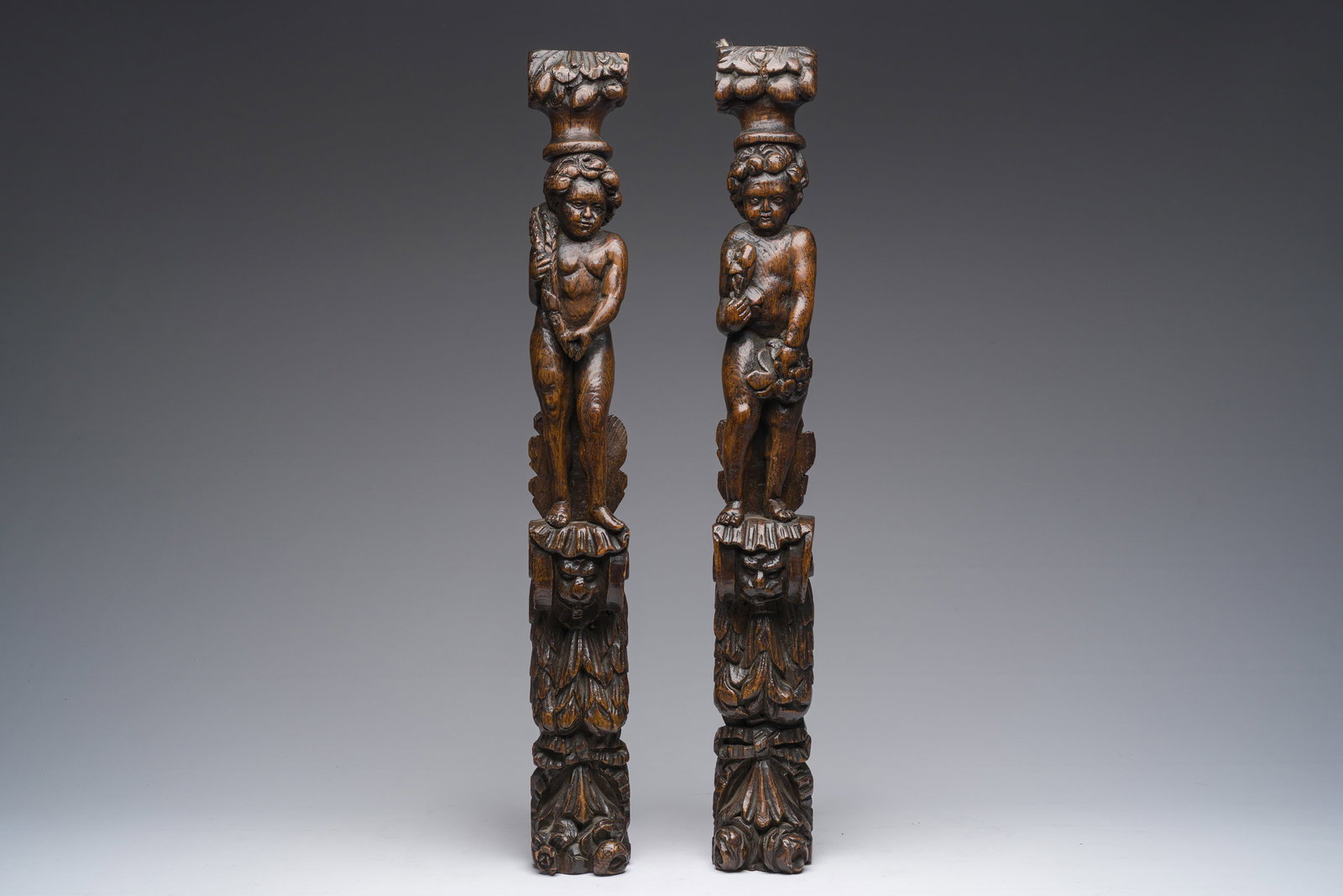 A pair of Flemish oak caryatids in the shape of a standing youth with a stalk of grain or flowers in (1 of 8)
