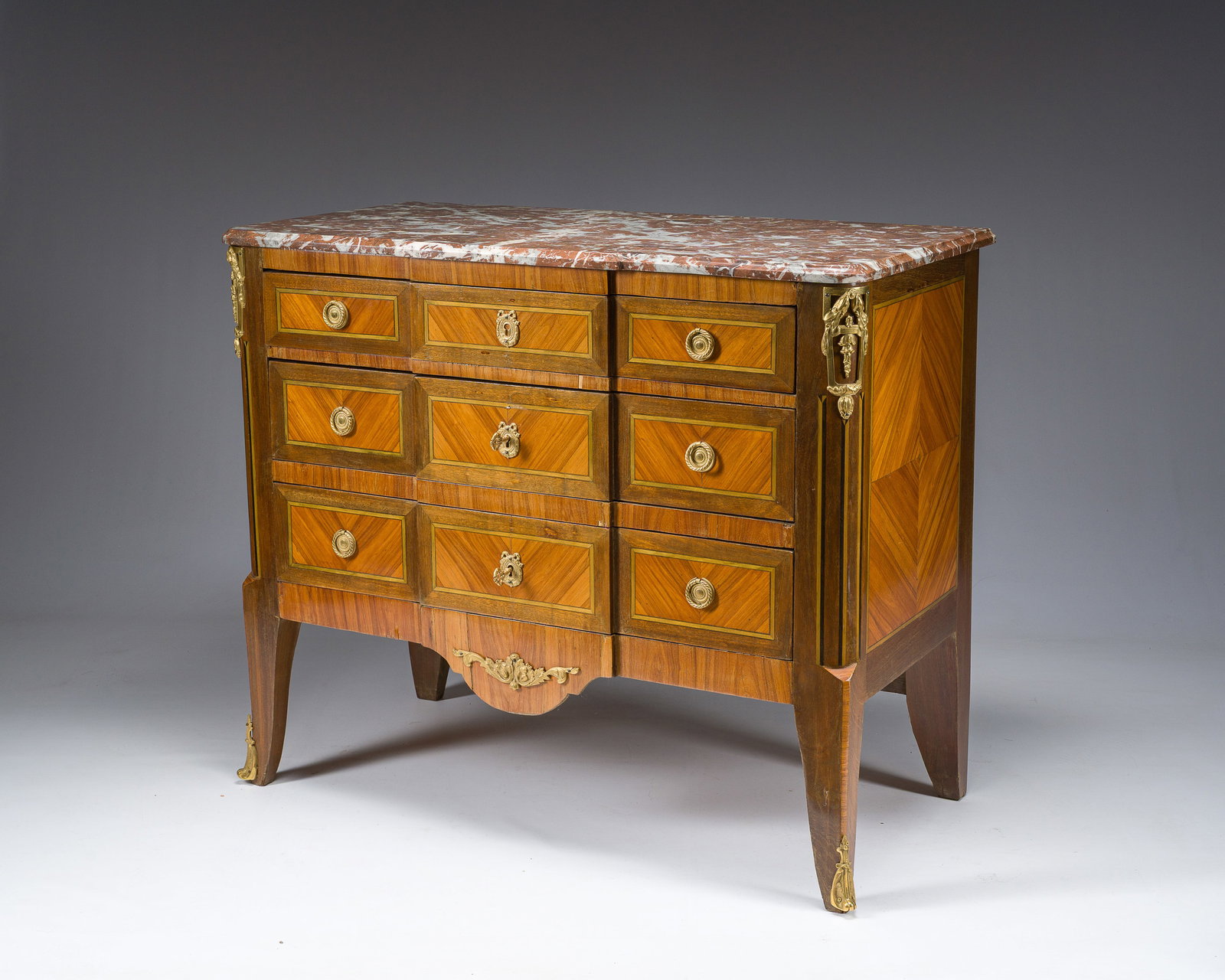 A French Transition style gilt bronze mounted marquetry chest of drawers with red marble top, (1 of 6)