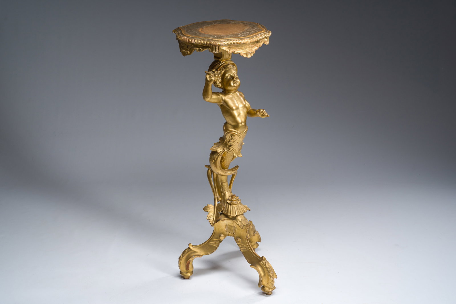 An Italian carved and gilt wooden tripod side table with a merman, 19th C. (1 of 10)