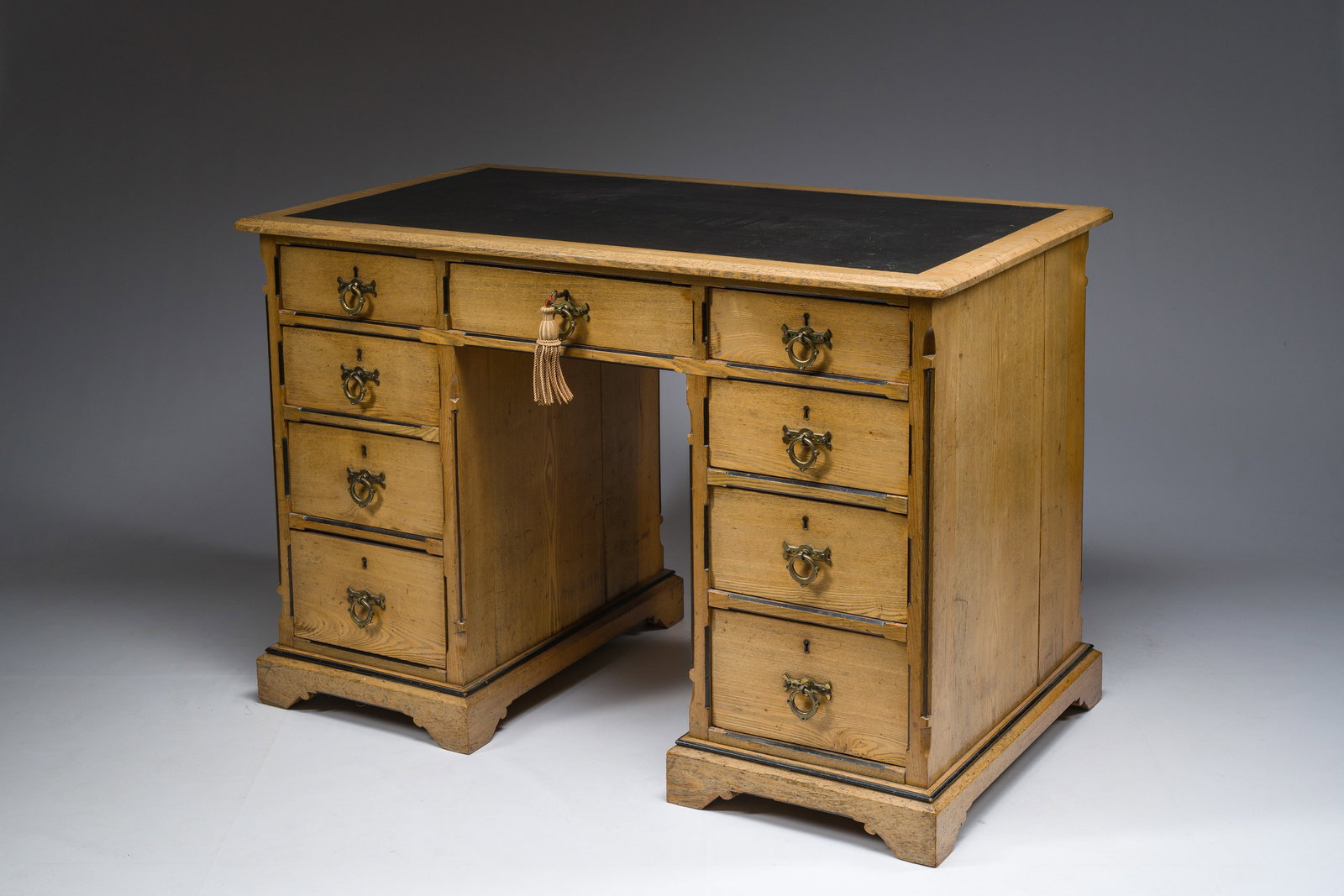 An English nine-drawers wooden pedestal desk with ebonized wooden inlay and leather top, Garnett and (1 of 7)