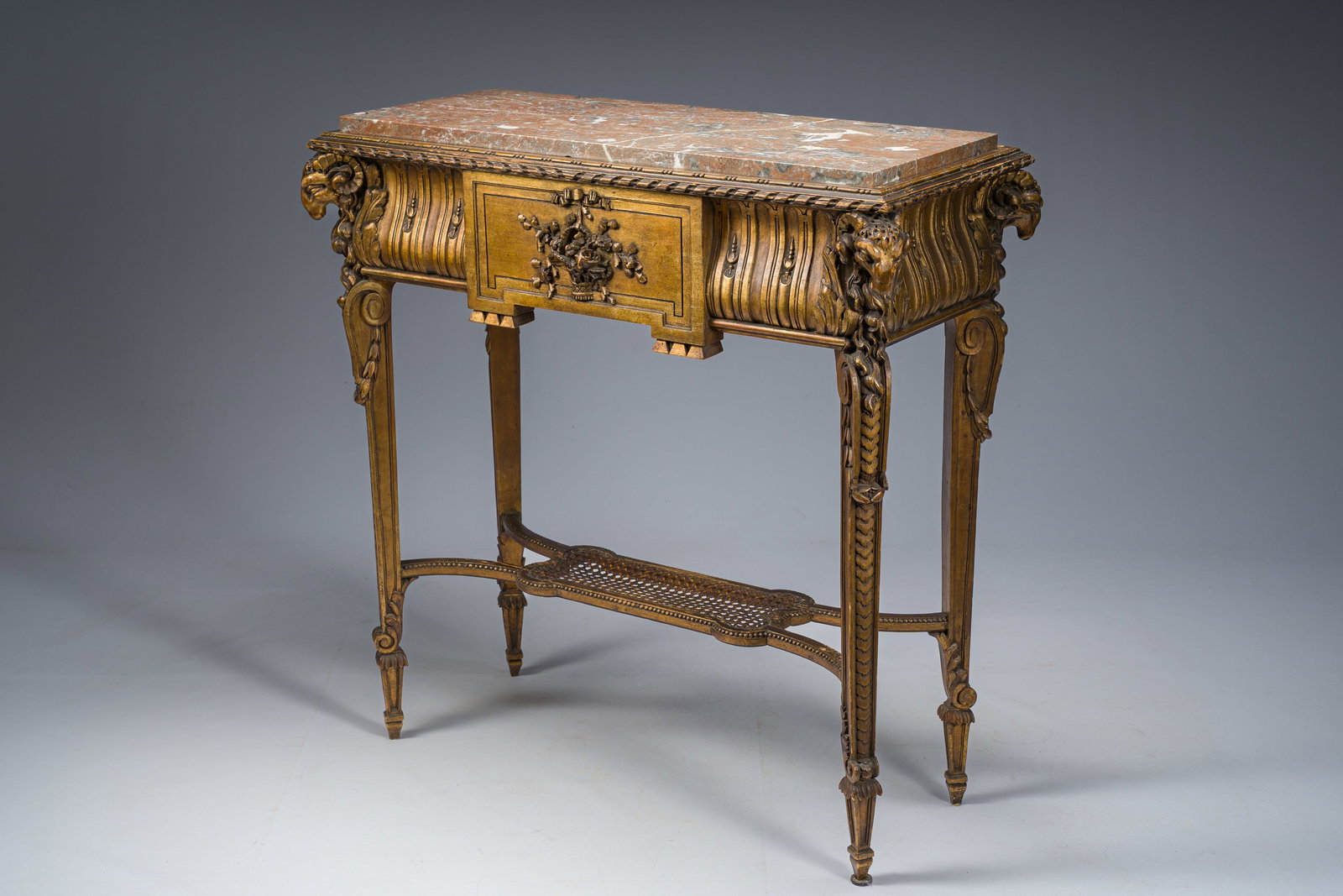 A French Louis XVI style gilt and carved woorden side table with ram's heads and a red marble top, (1 of 8)