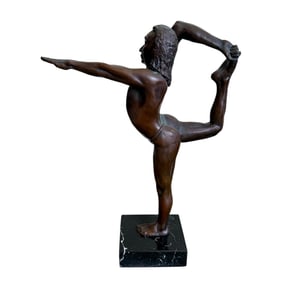 Bronze statue of man stretching leg.