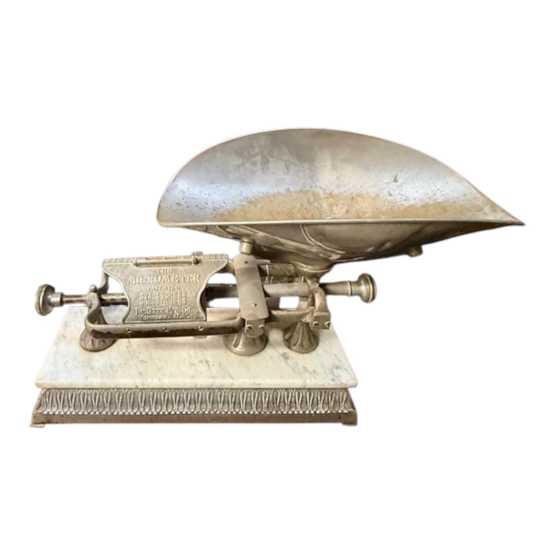 Antique “The Micrometer" Cast Iron Balance Scale with Marble Base: This antique cast iron balance scale, marked “The Micrometer,” features a substantial metal weighing tray and an ornate mechanism mounted on a carved marble base. The decorative detailing alon