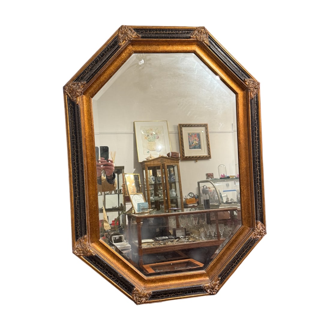 Decorative Octagonal Wall Mirror with Oxblood-Style Frame: A decorative octagonal wall mirror featuring a bold molded frame with carved corner ornamentation and a rich polychrome finish. The frame displays deep red and black tones with gilt accents, commonly