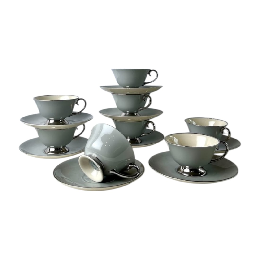 Flintridge China Tea Cup and Saucer Set: Set of 8, 16 pieces. Vintage Flintridge China tea set featuring a refined gray accent design. This lot includes eight teacups with eight matching saucers, suitable for entertaining, display, or adding