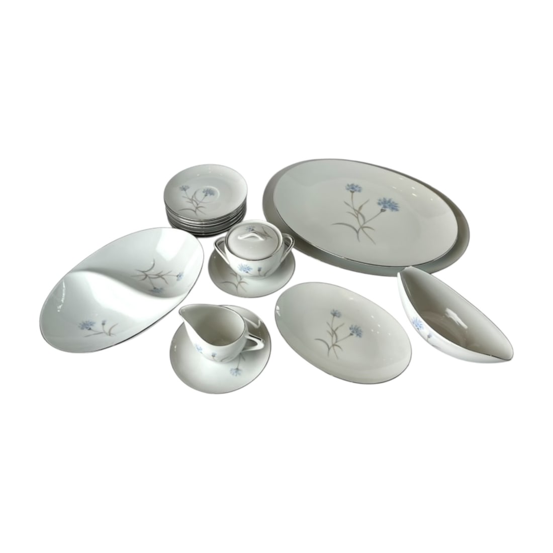 Sango Blue Floral 19-Piece Dinnerware and Serving Set: Includes one divided serving bowl, a creamer and sugar bowl, 2 dinner plates, 11 side plates, a gravyboat with underplate. Charming 19-piece Sango dinnerware and serving set featuring a blue floral de