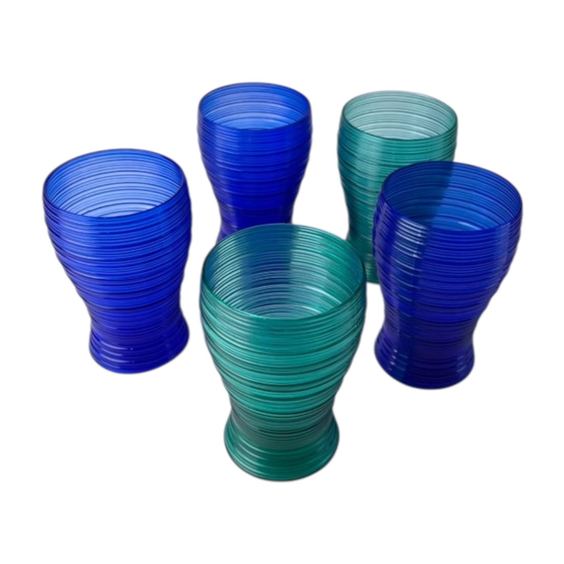 Set of 5 Vintage Imperial Glass Spun Tumbler: Decorative set of five glass tumblers, including three blue and two turquoise. Each tumbler features a distinctive flared hourglass shape wrapped in tightly spaced, raised horizontal line/rings, creat